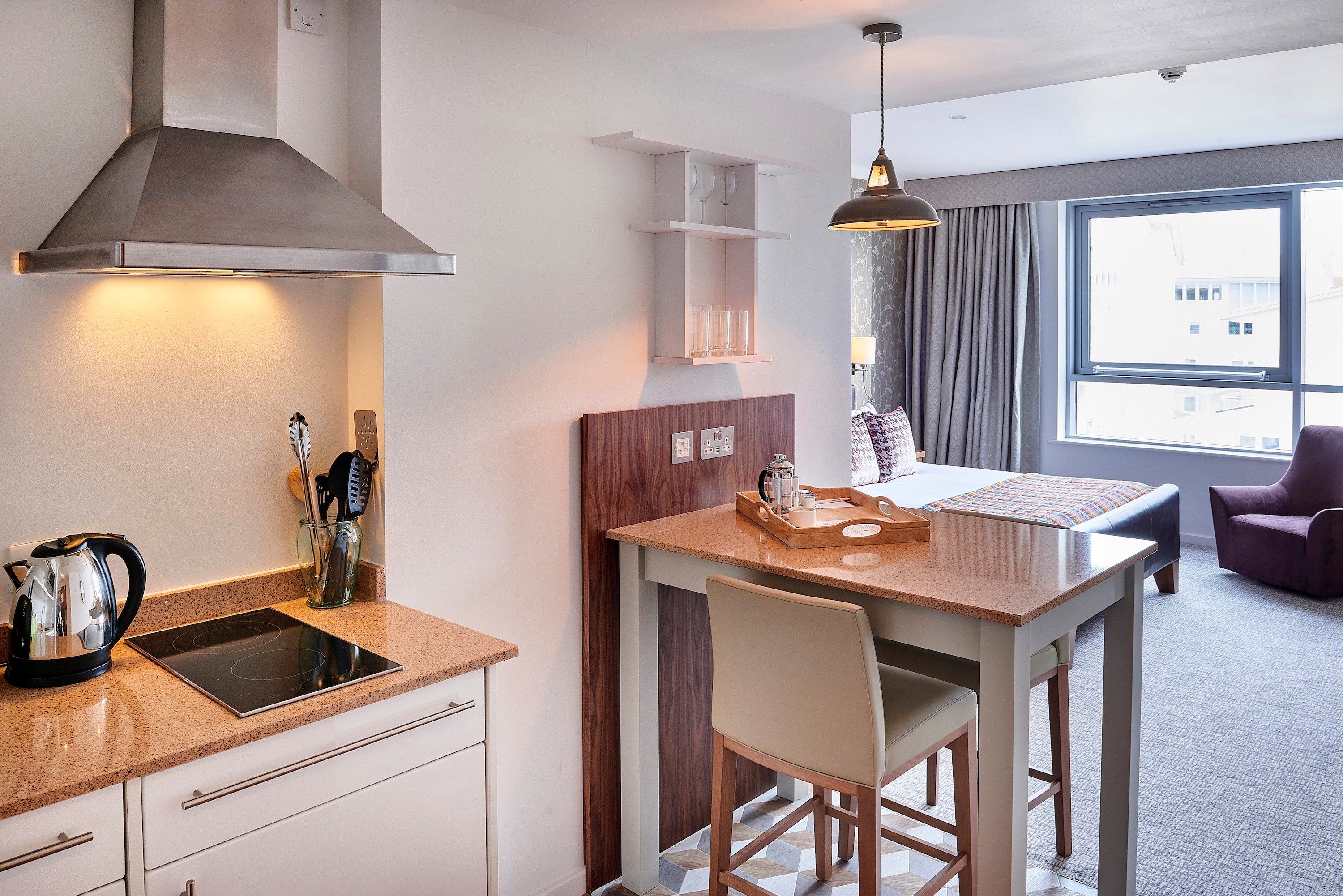image Kitchen outfitted with essential appliances and casual dining bar.