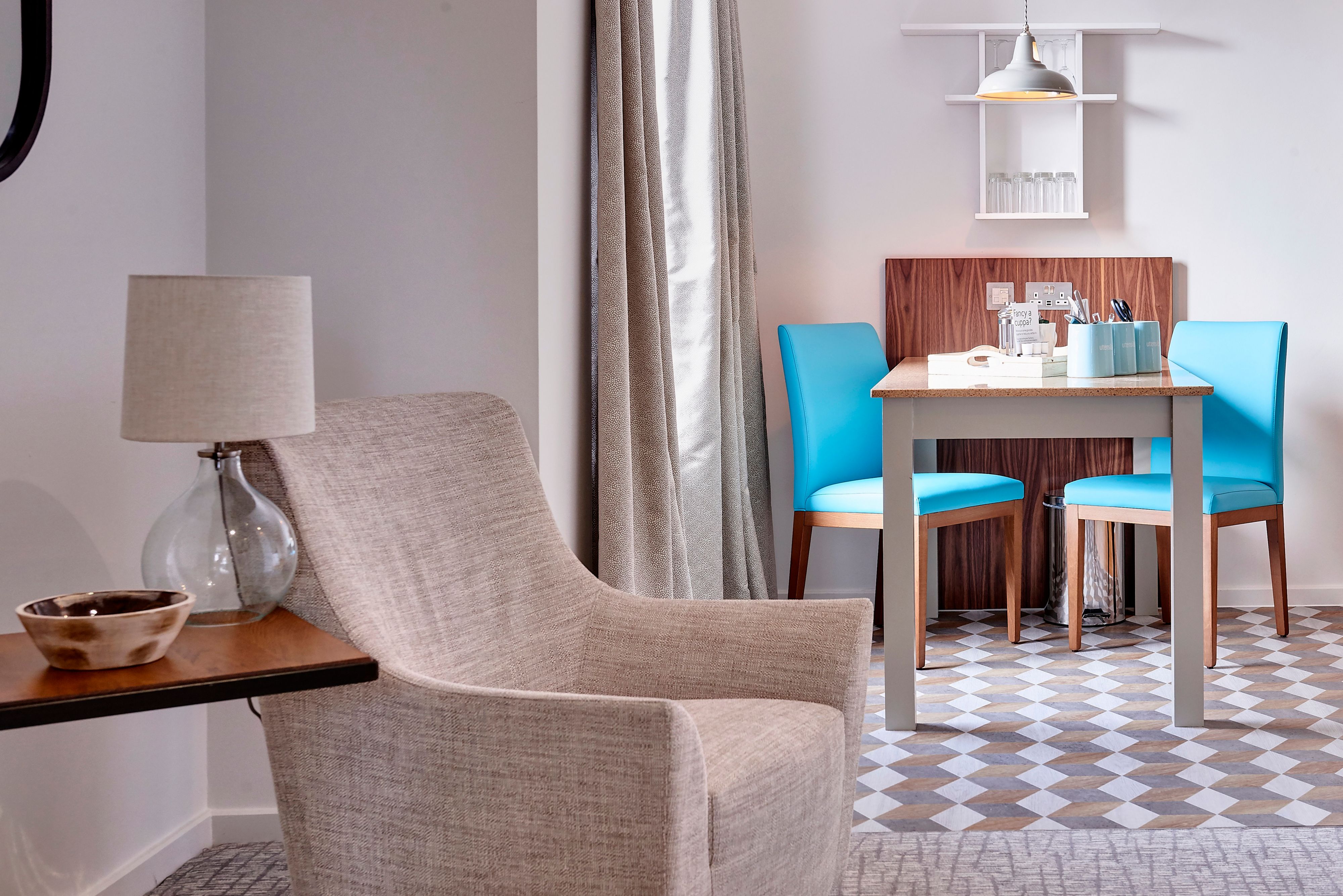 image Stylish dining area featuring vibrant blue chairs and natural light.
