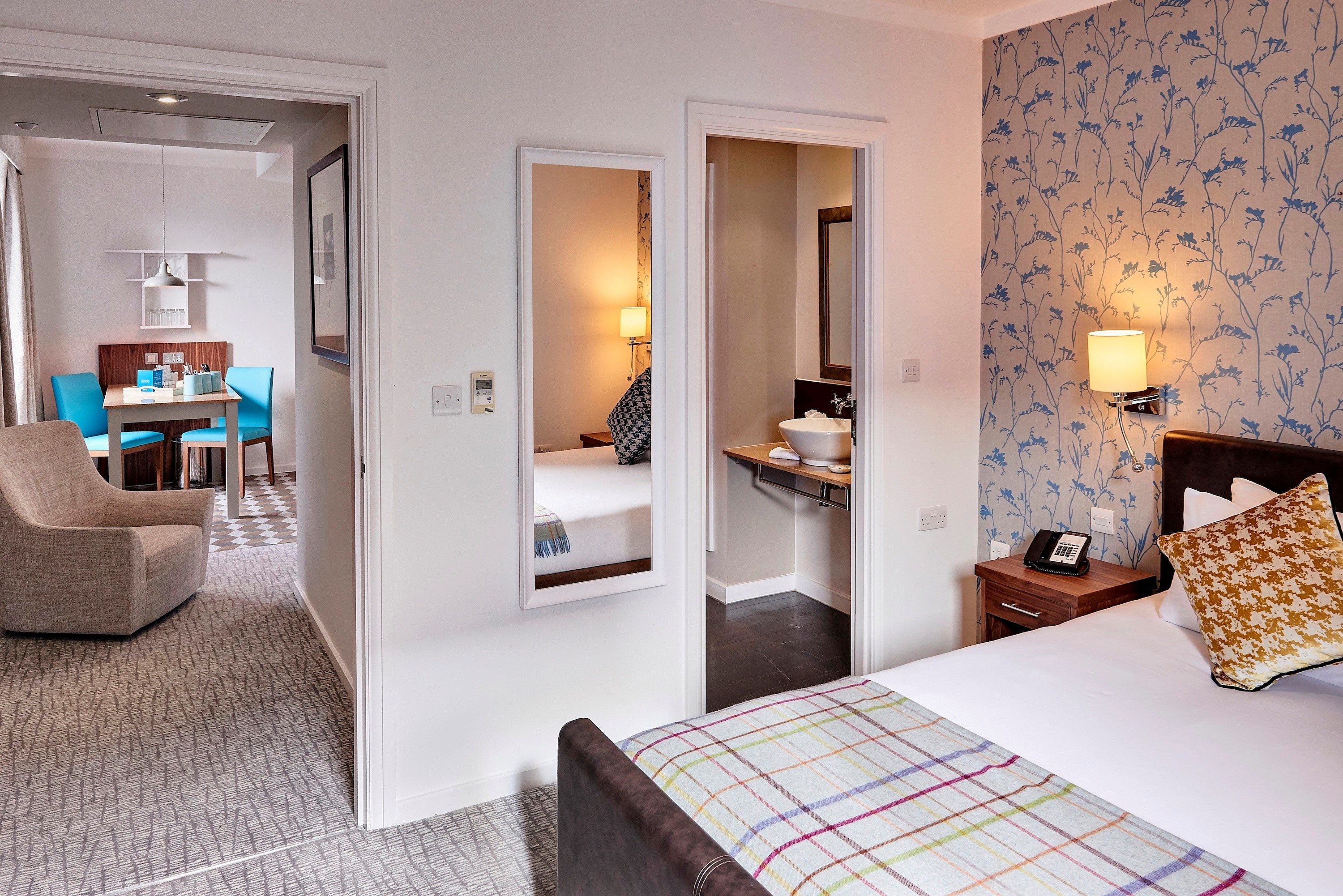 image Bedroom with a king bed, seating area, and en-suite bathroom visible.