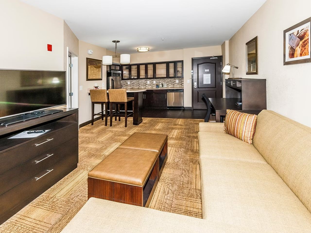 image Sofa bed in the living area opens to sleep additional guests, with a dedicated work desk nearby
