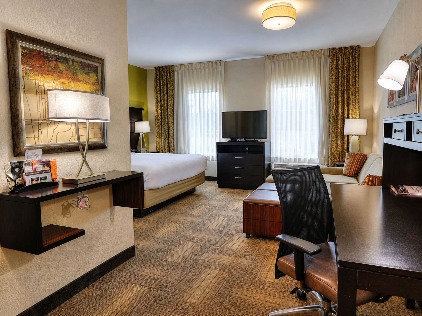image Studio bedroom with dedicated work desk and flat-screen TV.