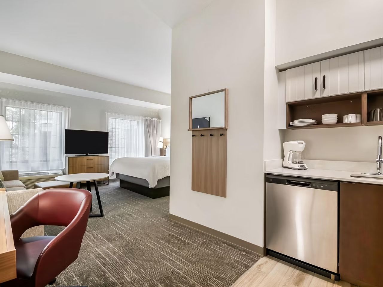 image Open-plan studio with king bed, sofa bed, workspace, kitchen, and flatscreen TV in one connected space