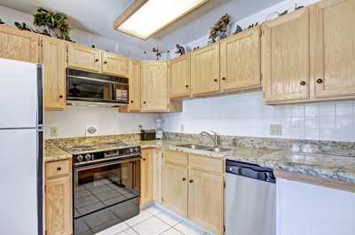 The fully-equipped kitchen features stainless steel appliances
