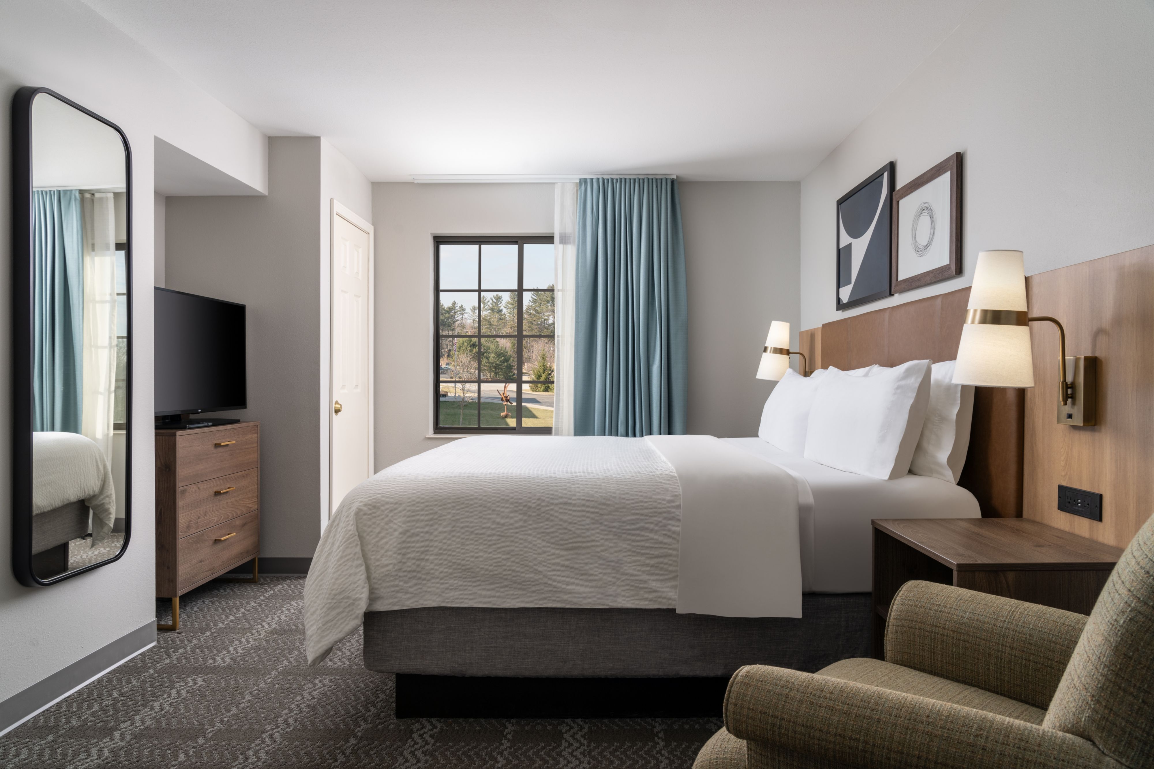 image Cozy king bedroom with stylish decor and abundant natural light.