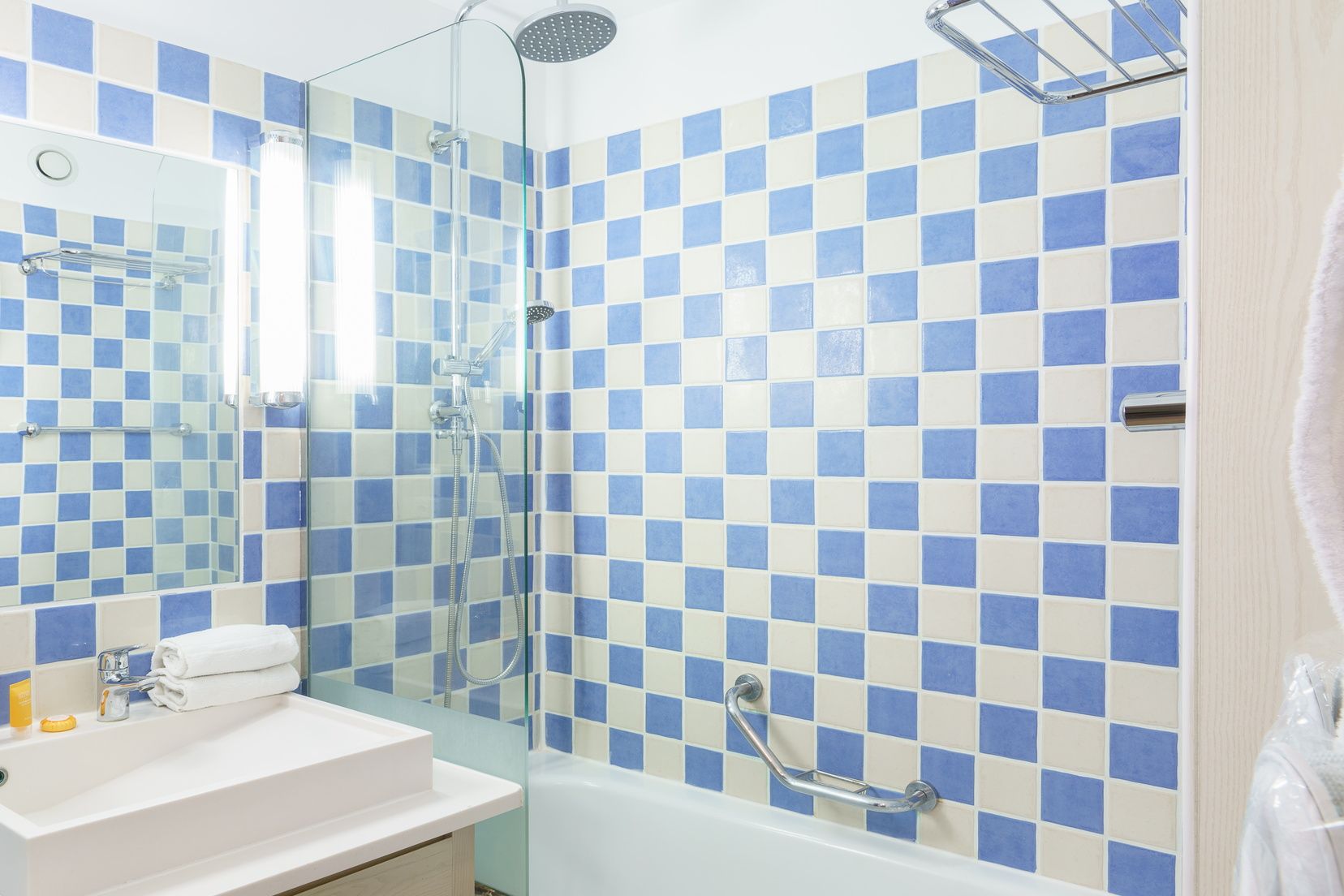 image Sink and tiled shower over the bathtub