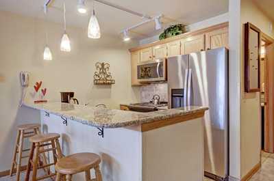 Take a seat at the breakfast bar and keep the cook company.