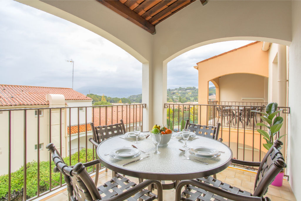 image Alfresco dining setup on a cozy balcony with scenic views.