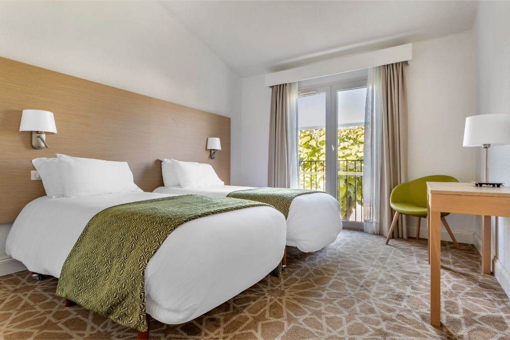 image Restful sleeping space with plush bedding and natural light.