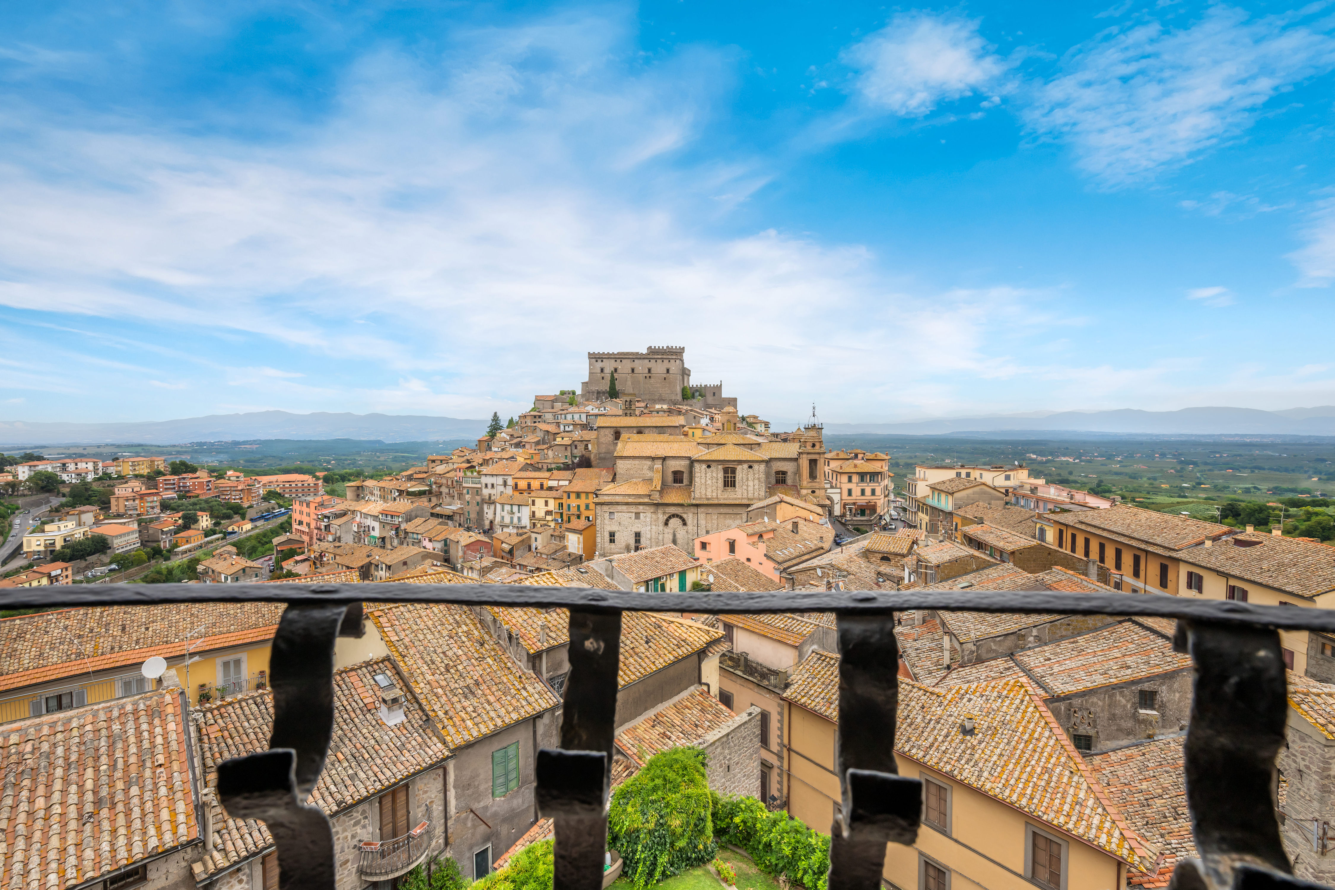 image Gaze across the terracotta rooftops of Soriano nel Cimino from a terrace perched high above the valley.