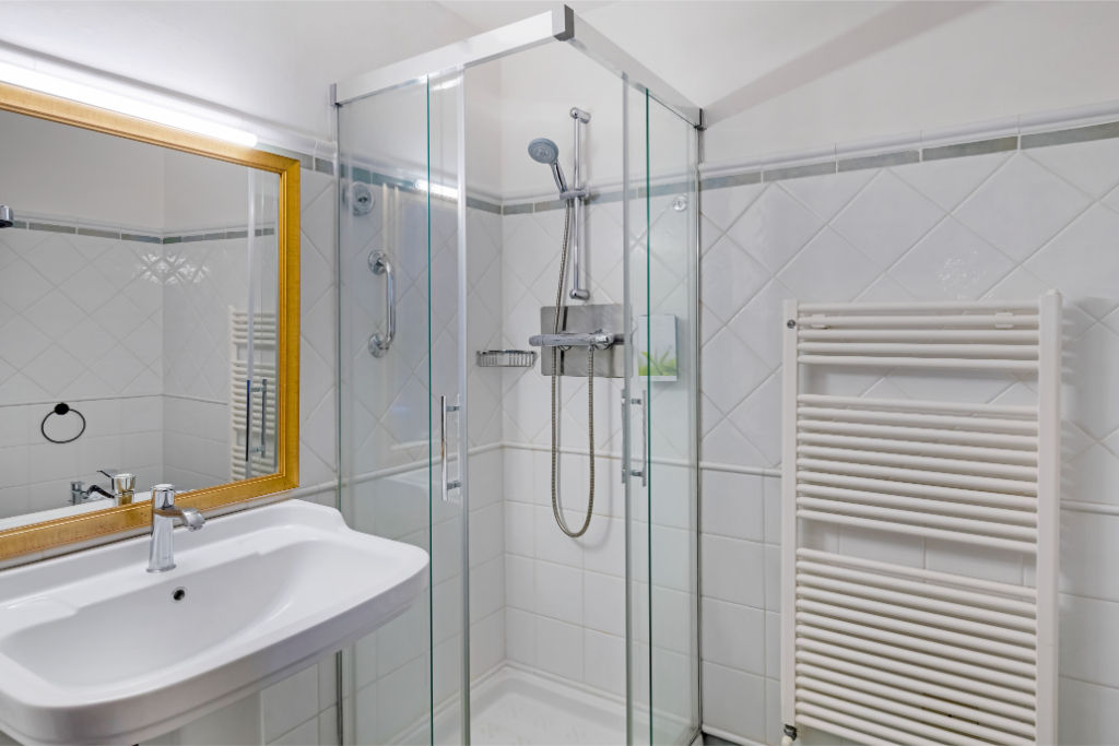 image A streamlined, all-white bathroom with clean lines that evoke a sense of calm and simplicity.