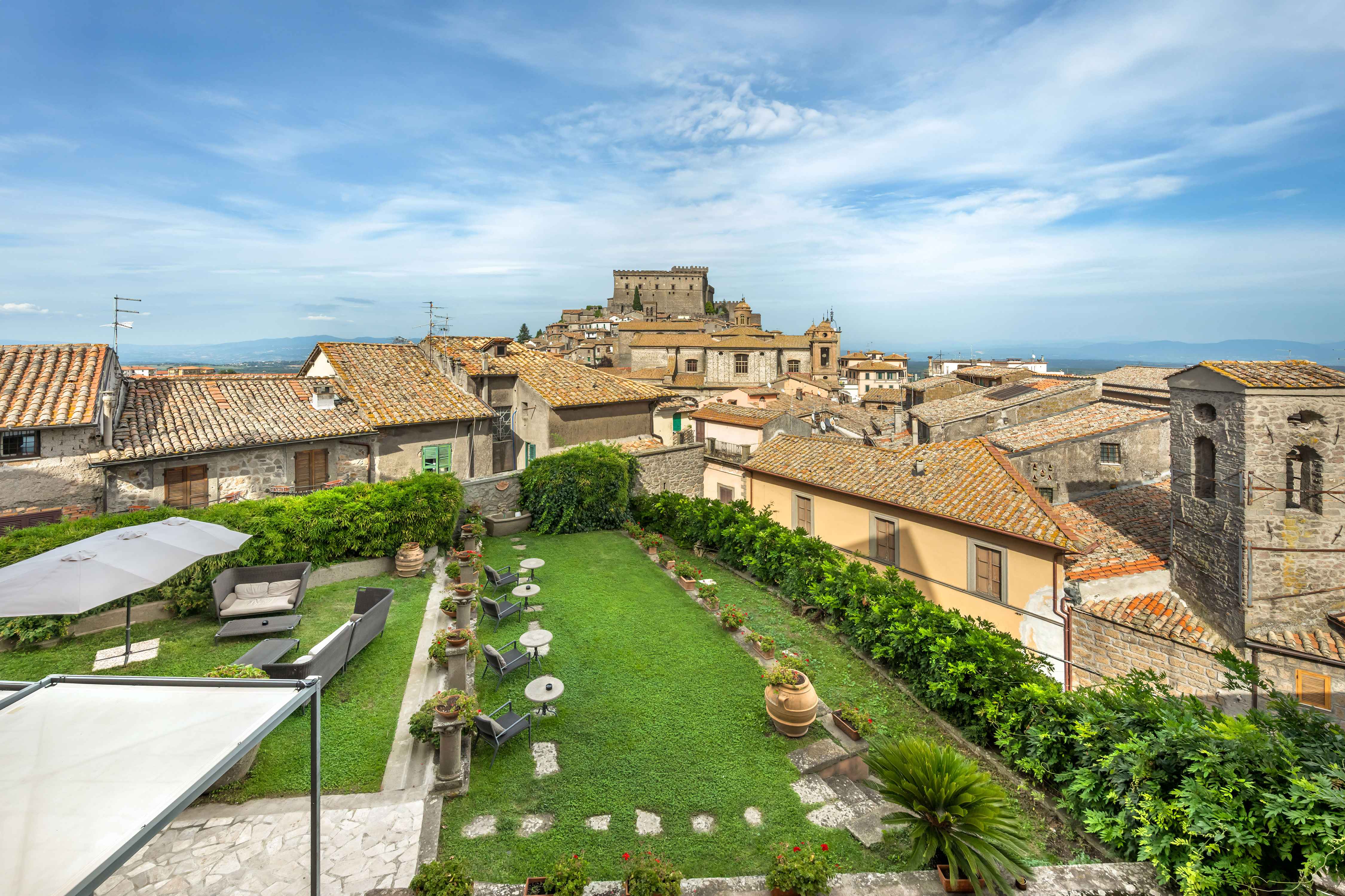 image Bask on a rooftop garden terrace with sweeping views of Soriano nel Cimino’s medieval skyline and castle.