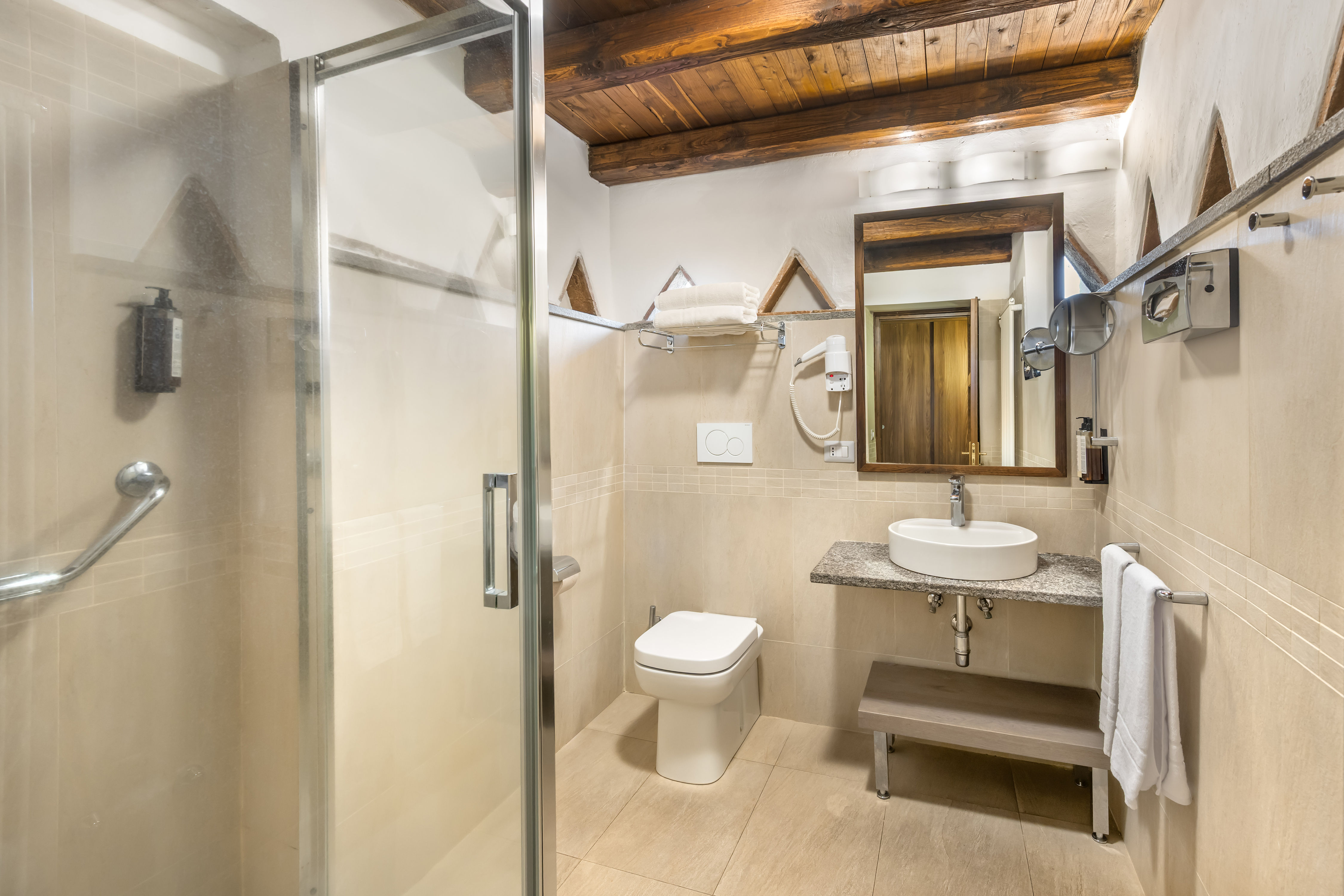 image Refresh in a stone-accented bathroom combining farmhouse textures with contemporary comfort.