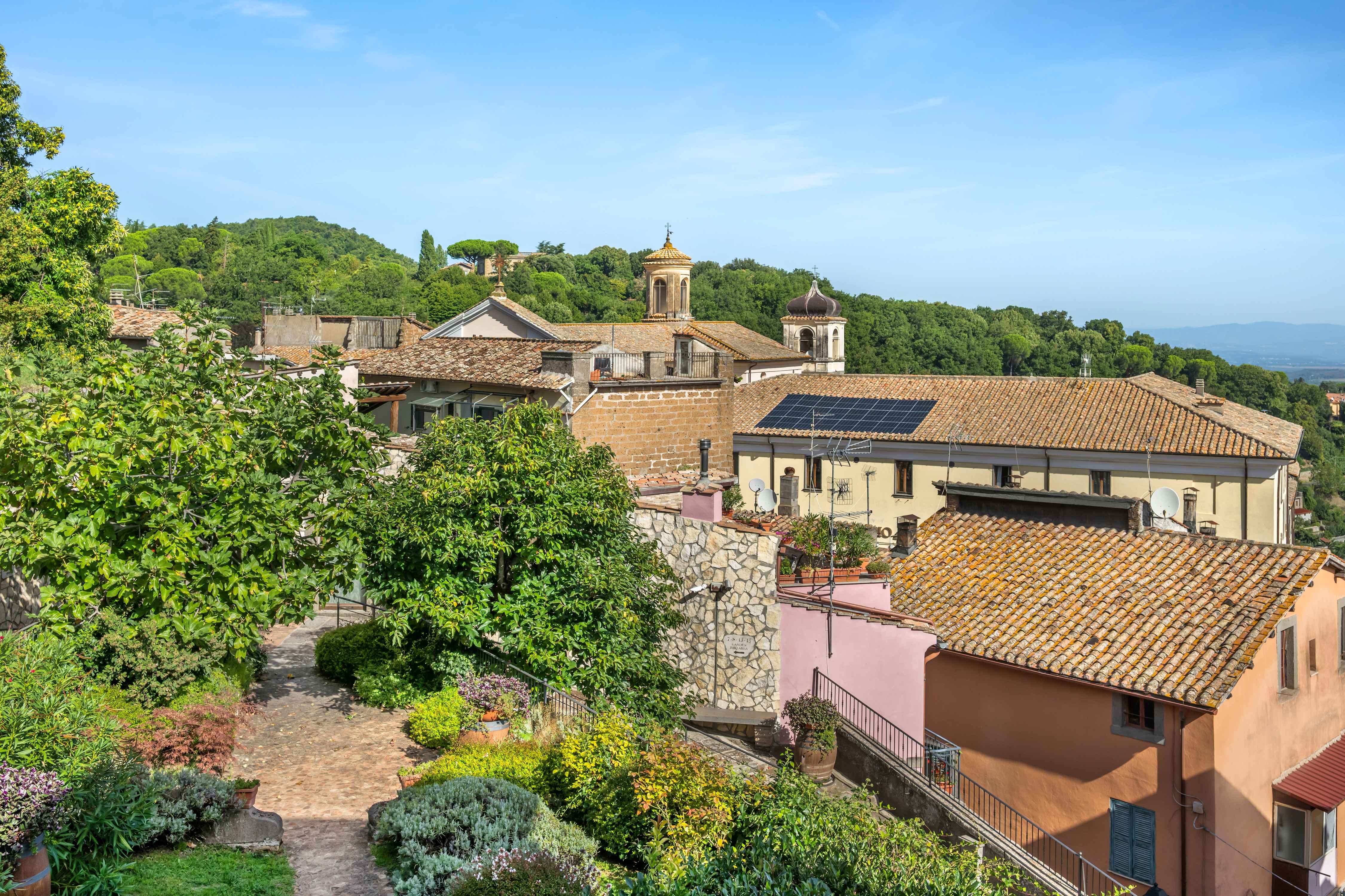 image Take in views of Soriano nel Cimino’s historic rooftops surrounded by lush greenery.