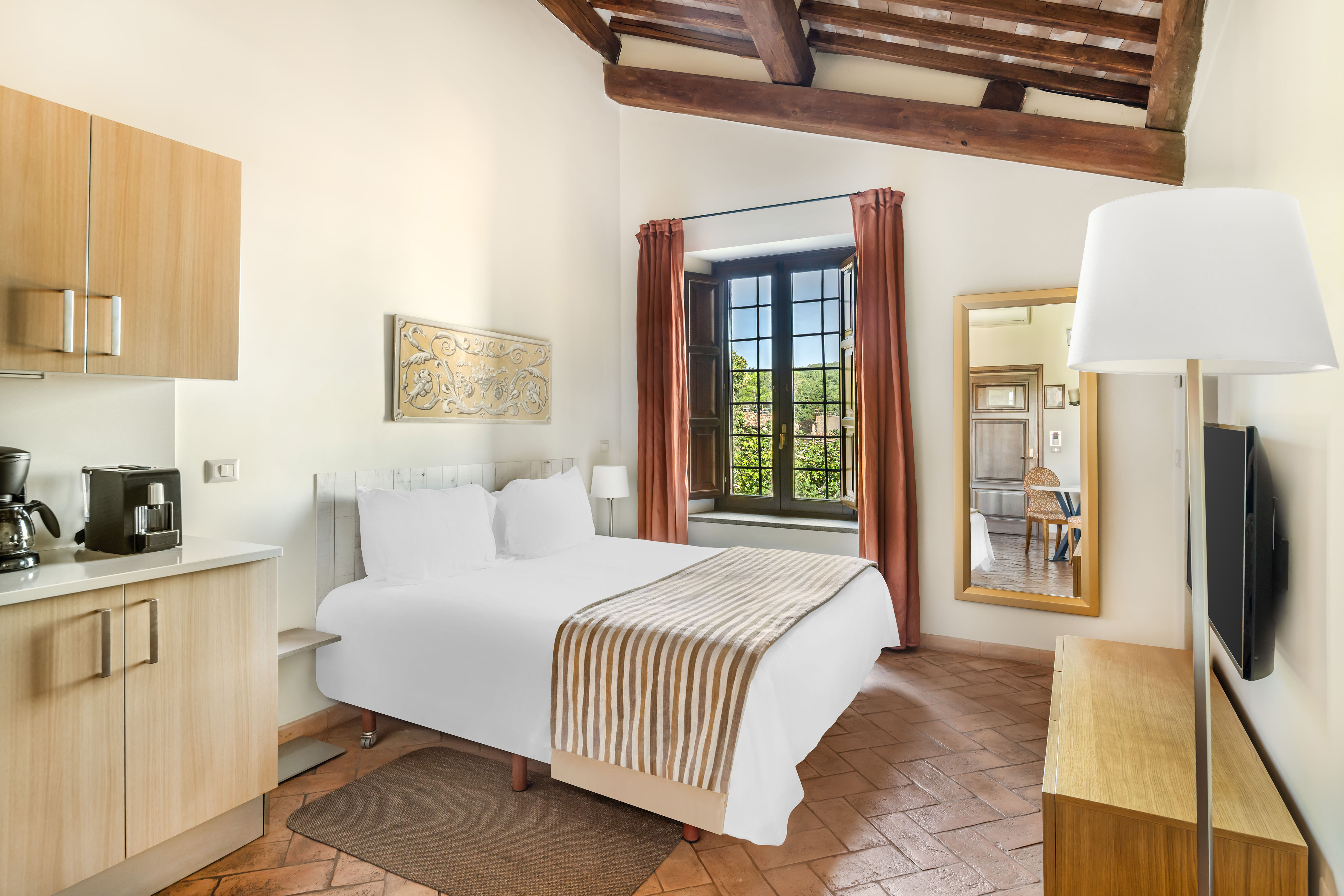 image Rest in a sunlit bedroom where modern simplicity meets rustic Italian charm.