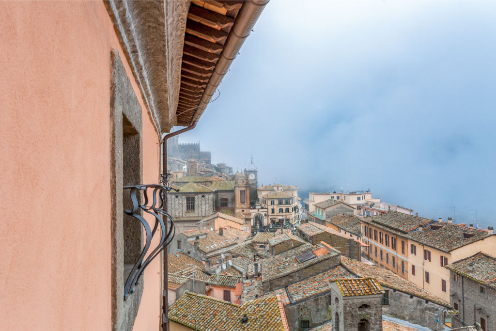 image Gaze out from a quaint balcony to the bustling cityscape below, a perfect backdrop for morning coffee or evening musings.