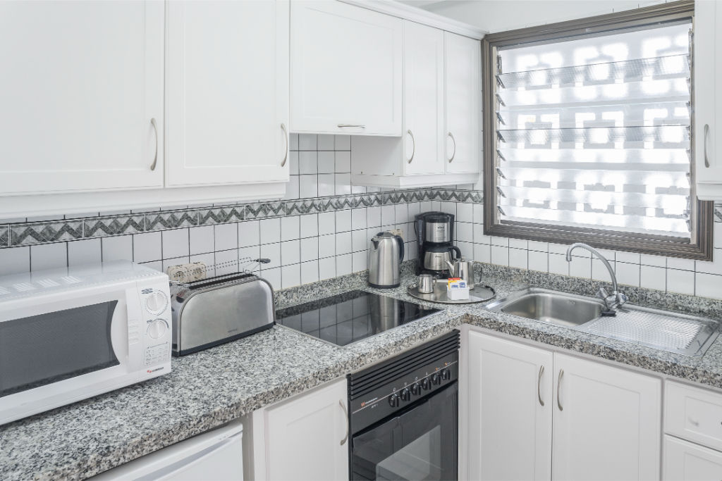 image Kitchen space with essential appliances, good for preparing simple meals.