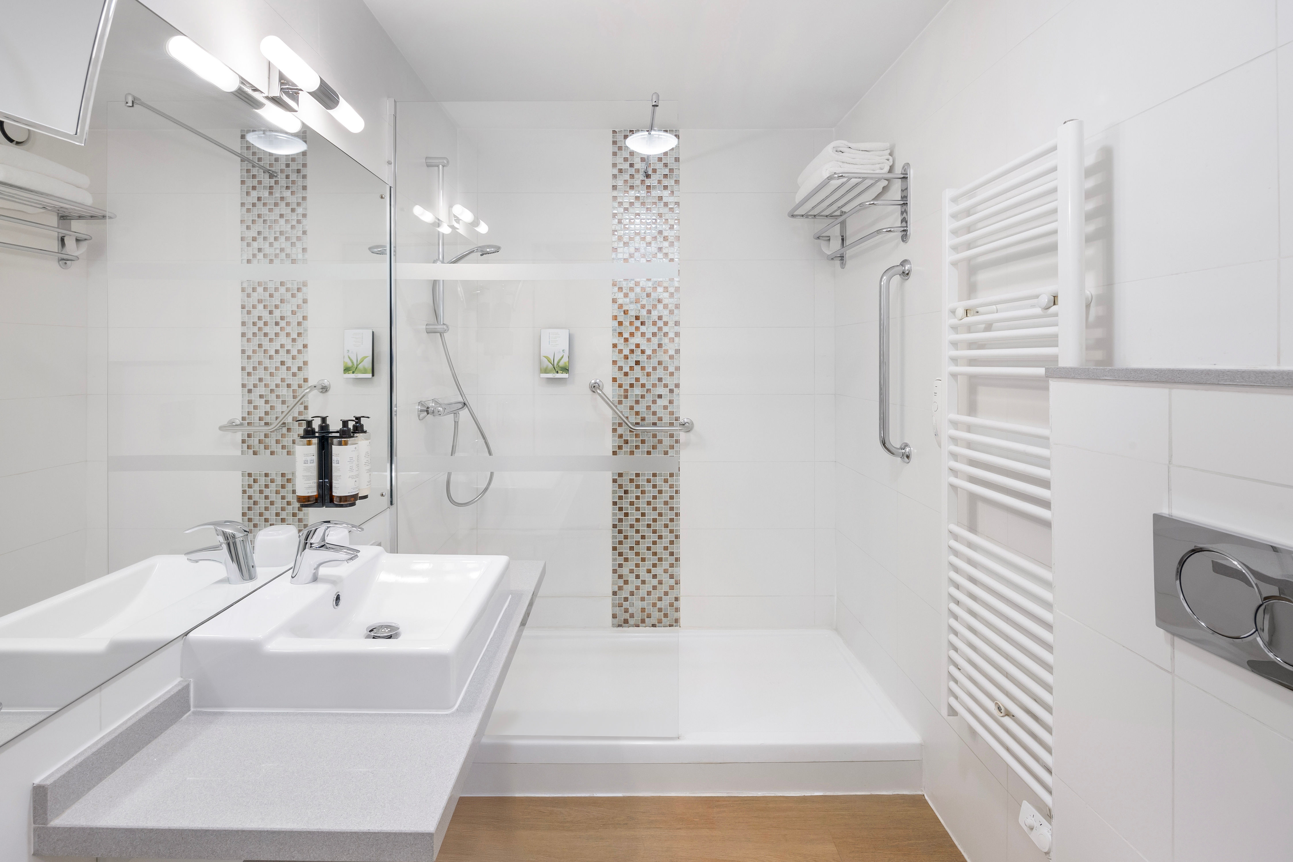 image A contemporary bathroom with a spacious walk-in shower, heated towel rail, and complimentary toiletries for your convenience.