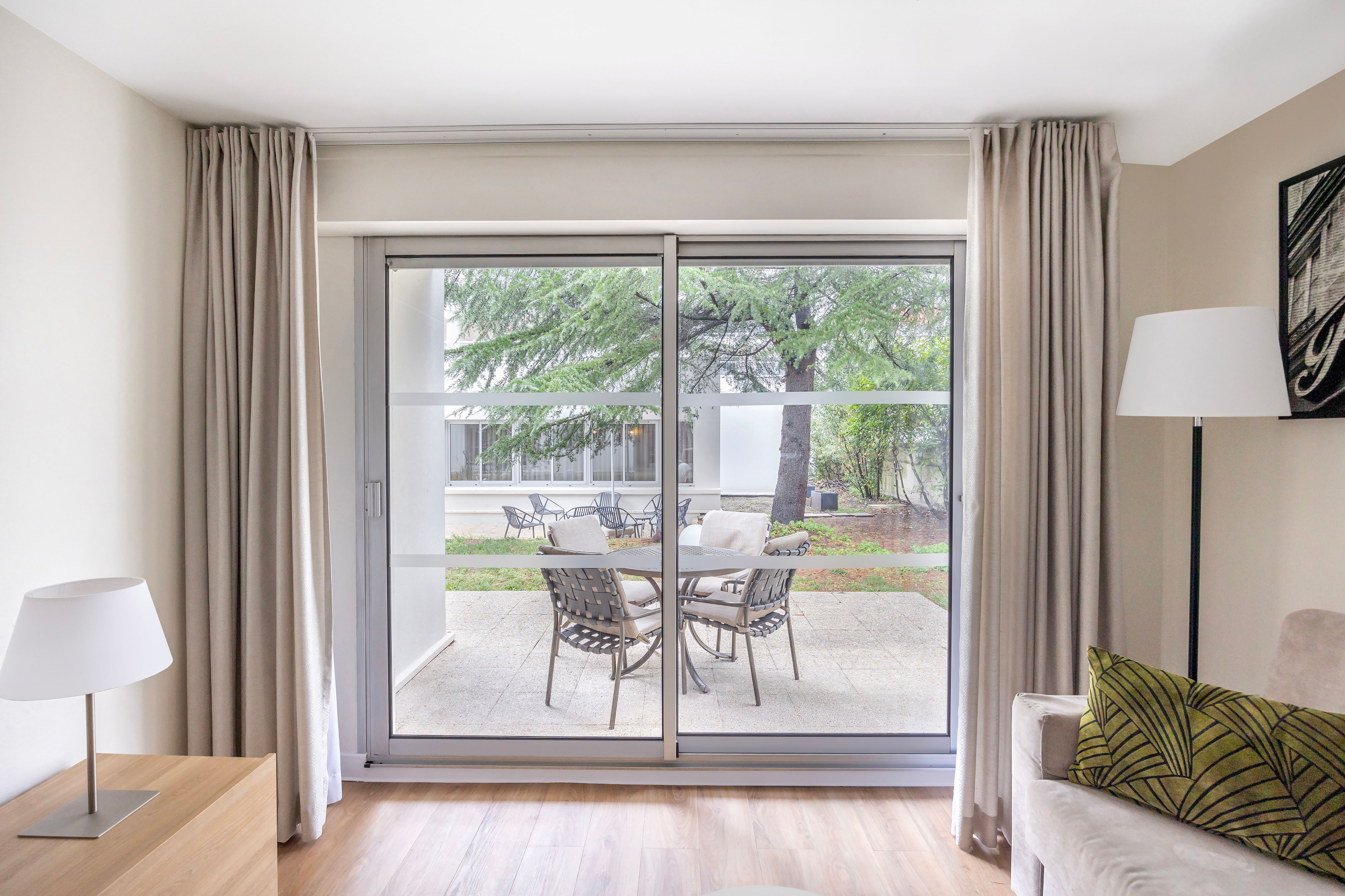 image Enjoy your morning coffee or a glass of wine on your private patio overlooking a peaceful green space.