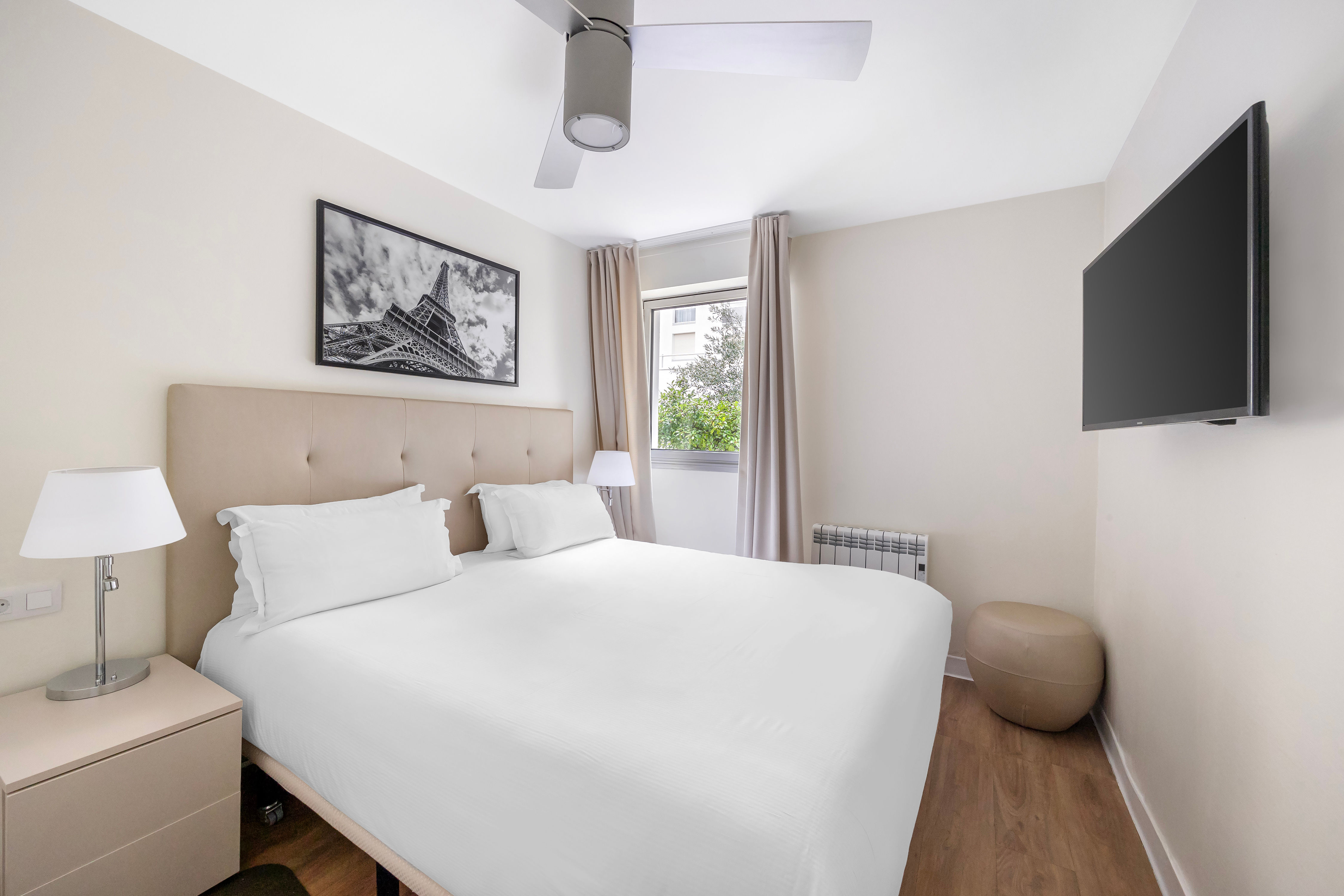 image Relax in the serene bedroom featuring a plush Double bed and Parisian-themed decor, perfect for unwinding after a day exploring the city.