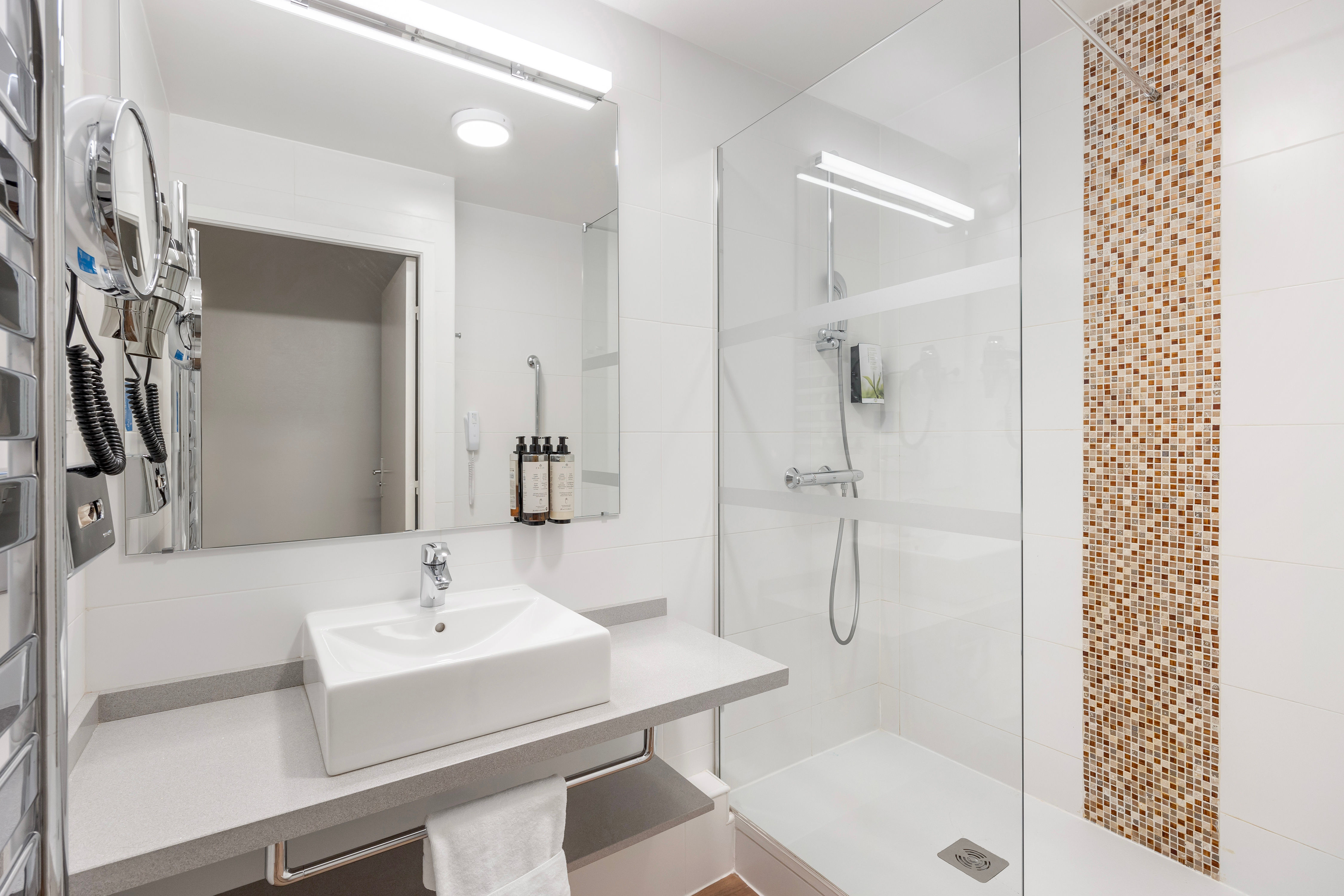 image Modern bathroom with a walk-in shower, heated towel rail, and complimentary toiletries to enhance your stay.