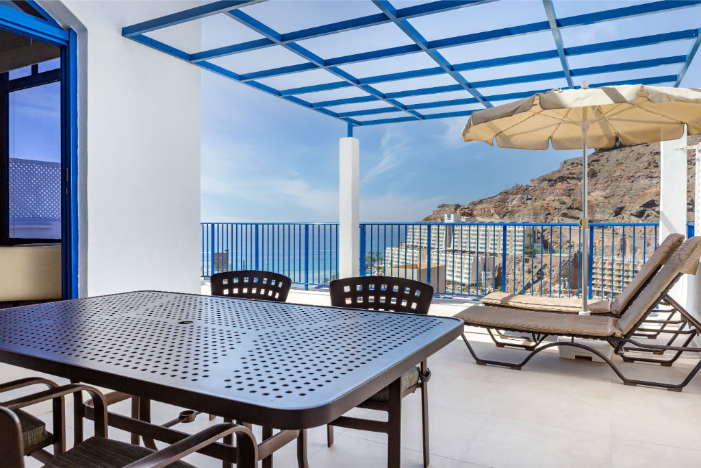 image Savor your morning under the azure sky on our sun-dappled terrace.