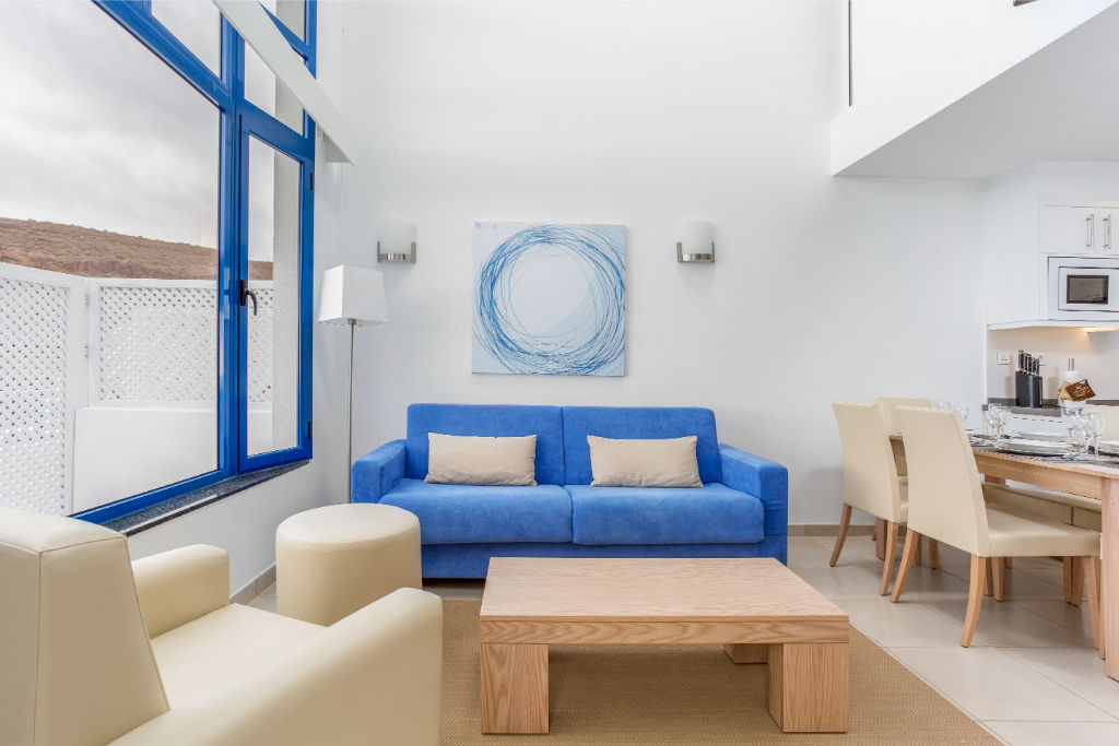 image Lounge in style in our chic living space with touches of ocean blue.