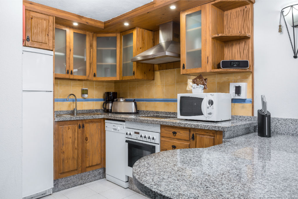 image Craft your favorite meals in our fully equipped kitchen with warm wooden accents.