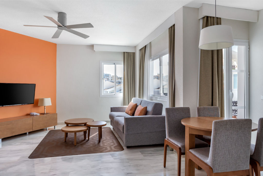 image Contemporary living area with plush seating and floor-to-ceiling windows, offering a space filled with natural light.