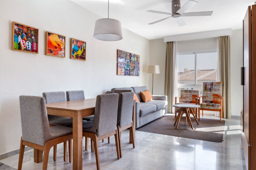 image Bright and airy dining area with contemporary art, perfect for enjoying meals in a stylish setting.