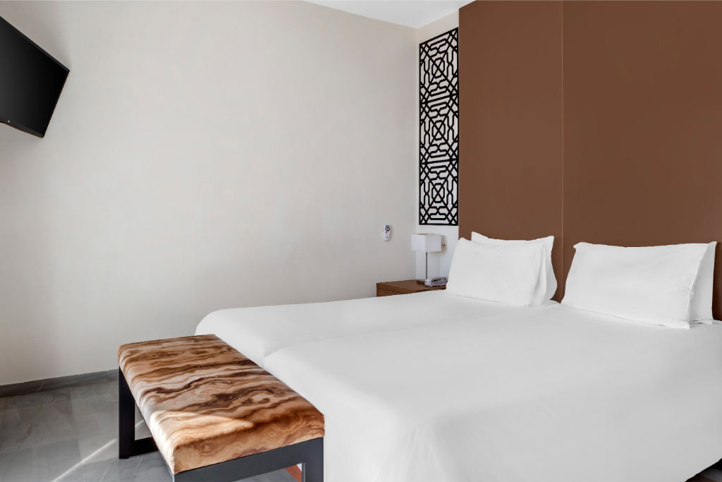 image Sleek and minimalist bedroom with a chic headboard, offering a tranquil retreat for guests.