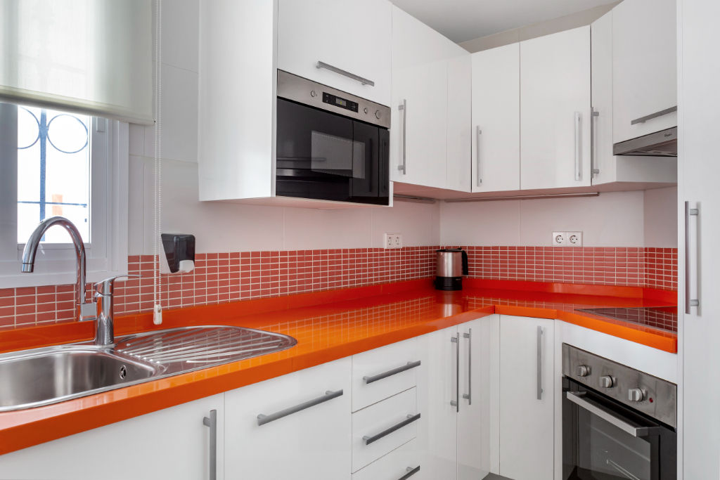 image Bold and vibrant kitchen with red accents, fully equipped for culinary enthusiasts.