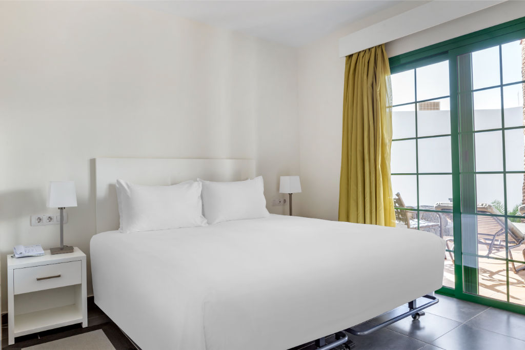 image Slumber in serenity in a bedroom adorned with soft, inviting hues and plush bedding.