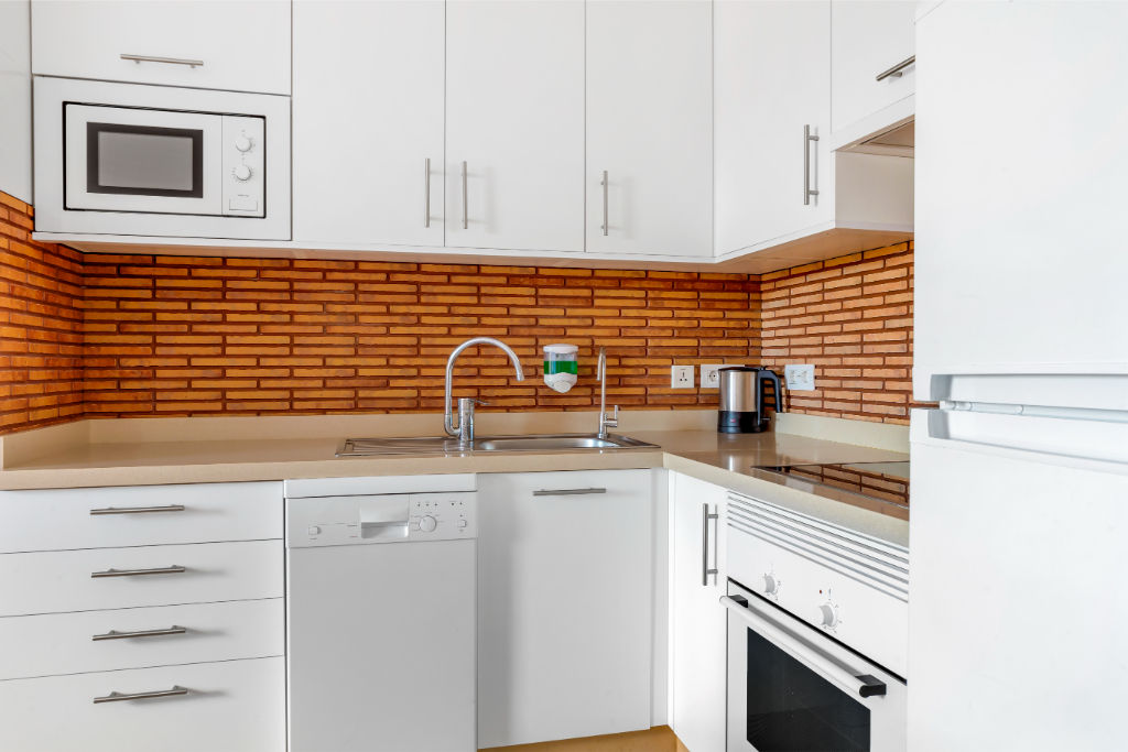 image Charming kitchen with brick accents, combining classic touches with modern conveniences.