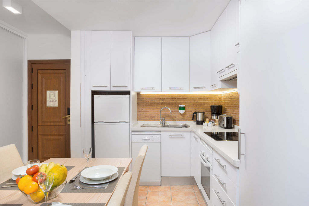 image Well-appointed kitchen space featuring modern appliances and a sleek design.