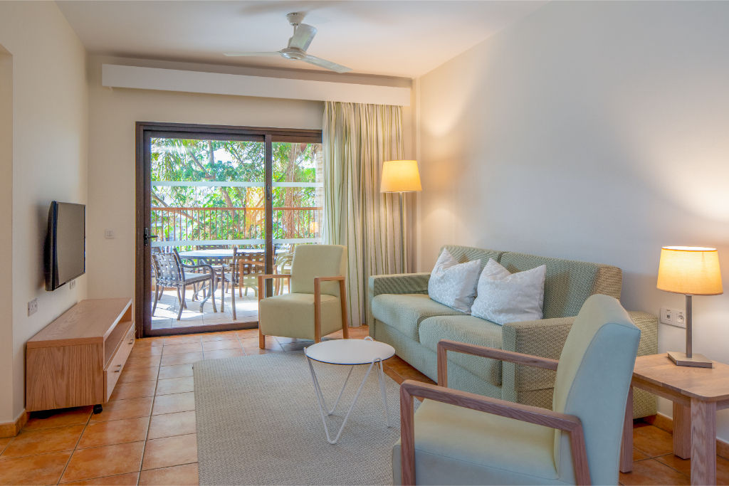 image Embrace the tranquility of this spacious living room that opens to nature's embrace on the balcony.