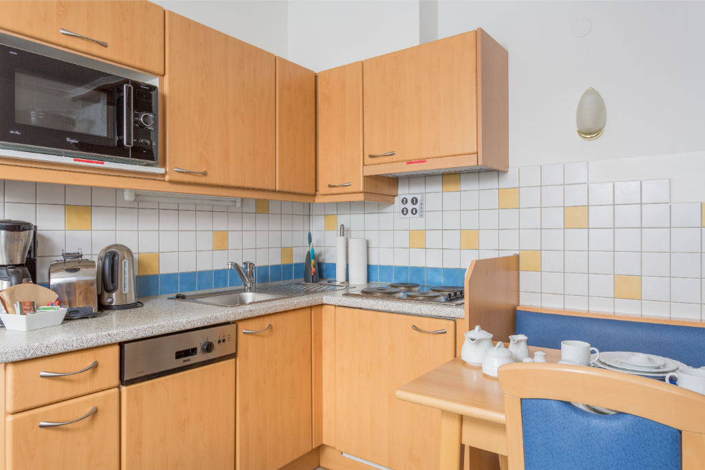 image Warm wood tones and all the essentials make this kitchen a home away from home.