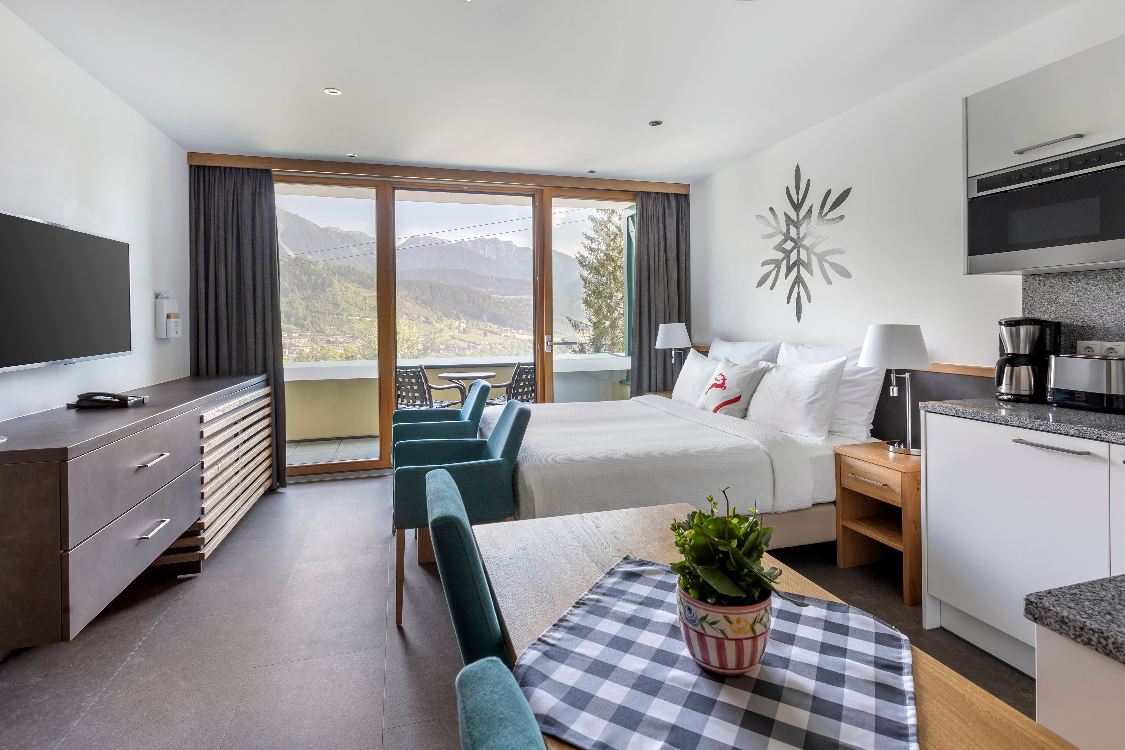 image Comfortable studio layout with large windows, mountain views, and modern furnishings.