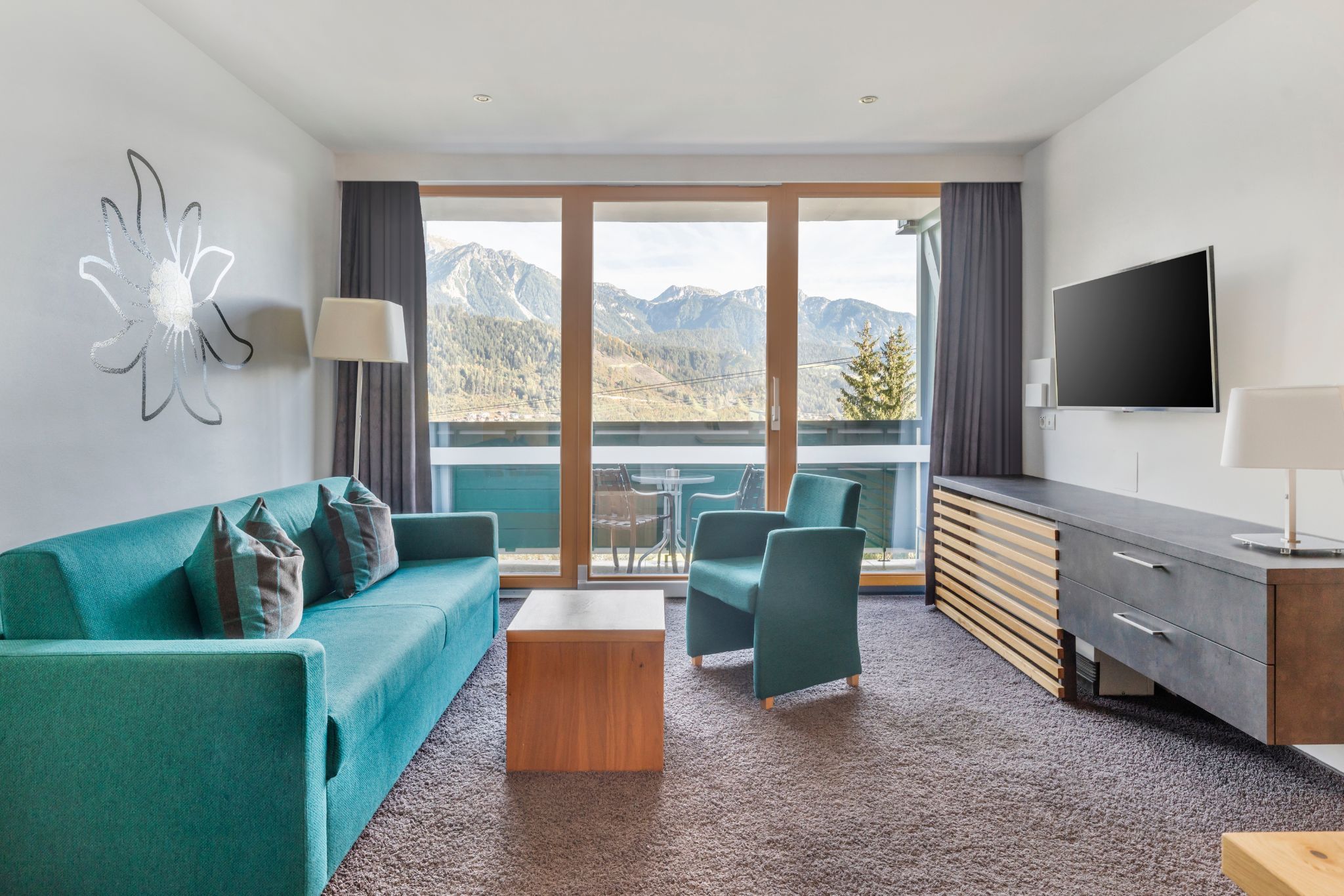 image This cozy 1-bedroom apartment in Schladming features a spacious living area with two single beds, a smart TV, and a fully equipped kitchen, complemented by a balcony offering breathtaking views of the surrounding mountains and forests.