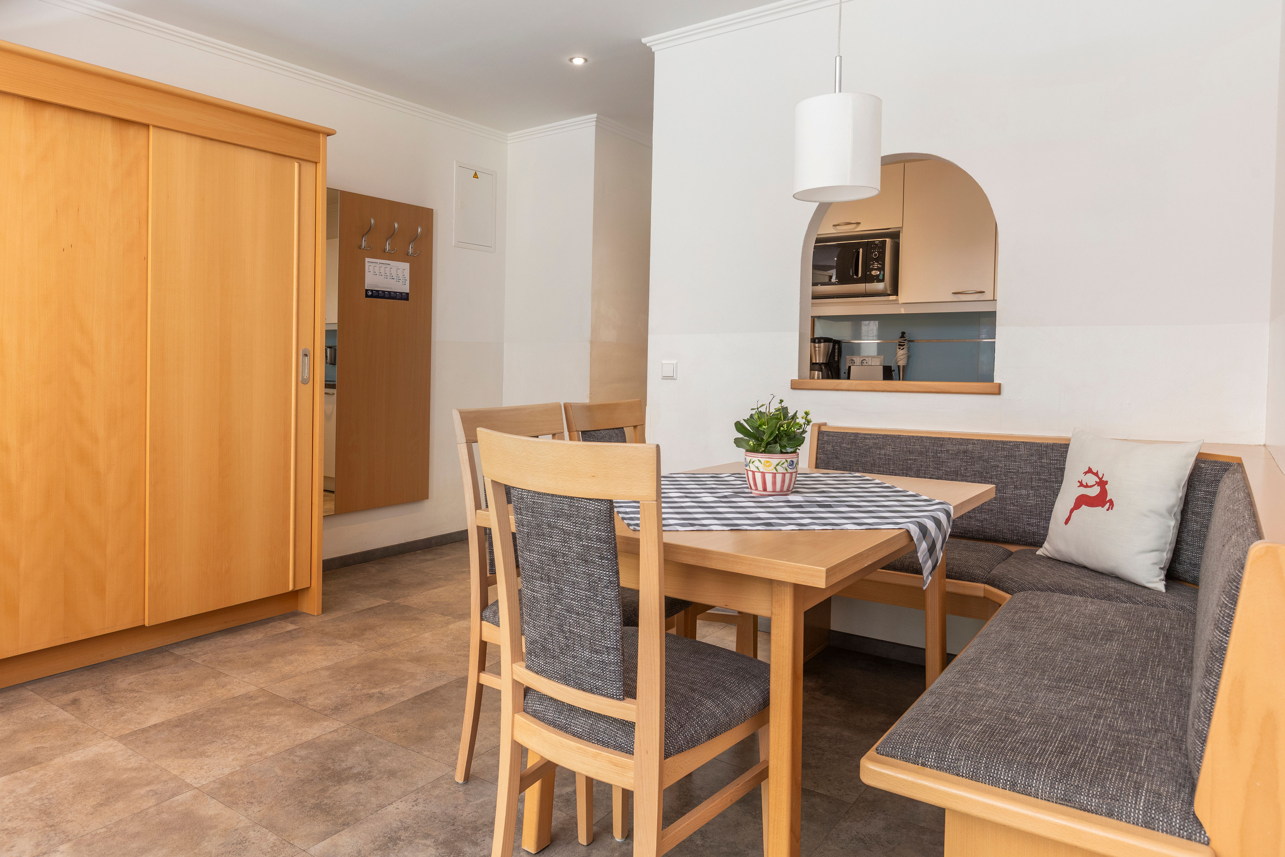 image The spacious dining area includes a charming wooden table surrounded by comfortable seating, seamlessly connecting to the fully equipped kitchen for convenient meal preparation.