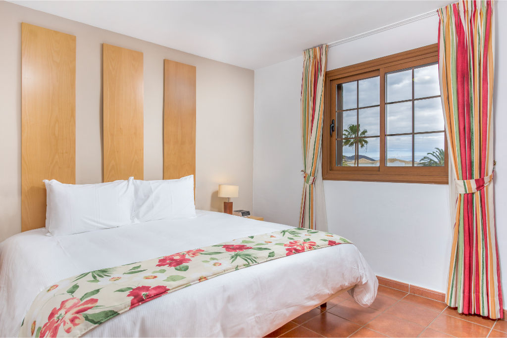 image Bright and welcoming bedroom with cheerful floral accents, offering a peaceful retreat.