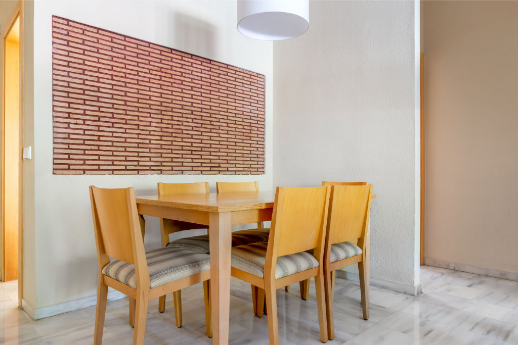 image A simple dining area with clean lines and a splash of color, perfect for casual meals and chats.
