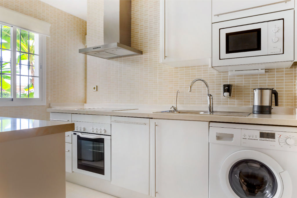 image A compact and efficient laundry area, neatly integrated into the kitchen space for ultimate convenience.