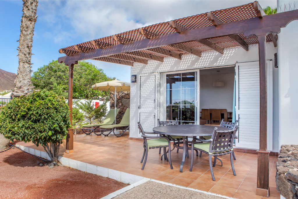 image Dine al fresco under the shade of our charming vine-covered pergola.