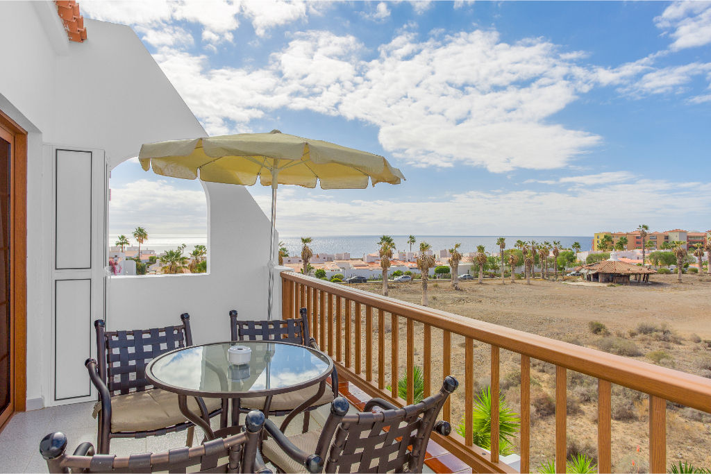 image Balcony seating area perfect for outdoor dining and enjoying the scenic horizon.