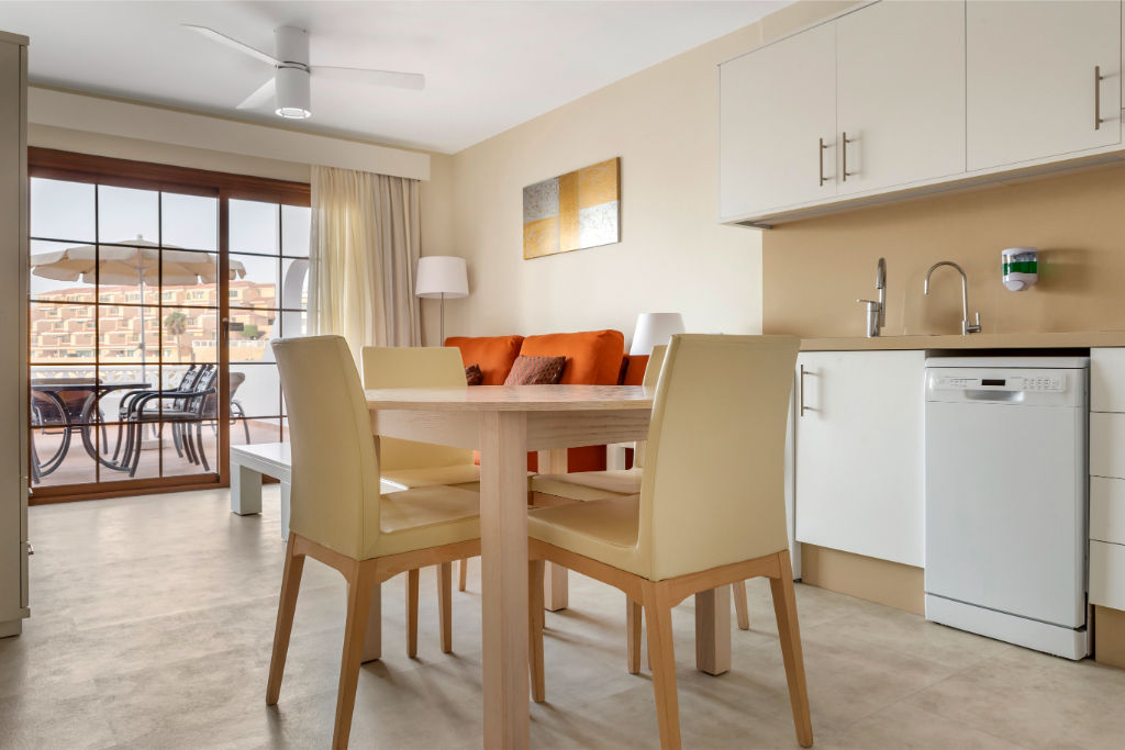 image Airy dining area with adjacent kitchen, ideal for family meals.