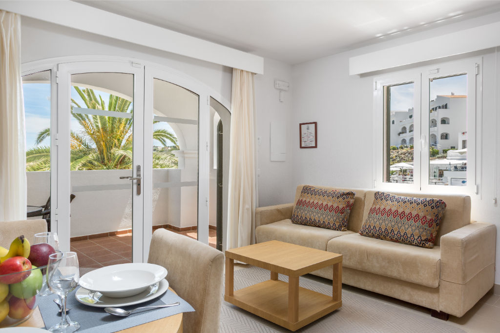 image Cozy living room with sofa bed and dining area, perfect for relaxation and meals.