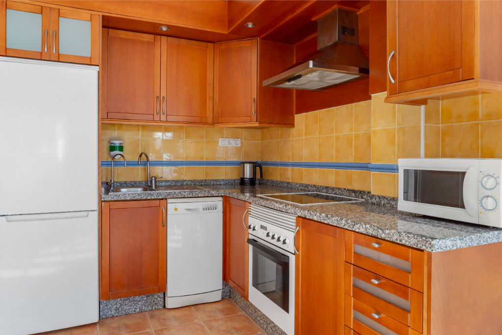 image Kitchen space with essential appliances for convenient meal preparations.