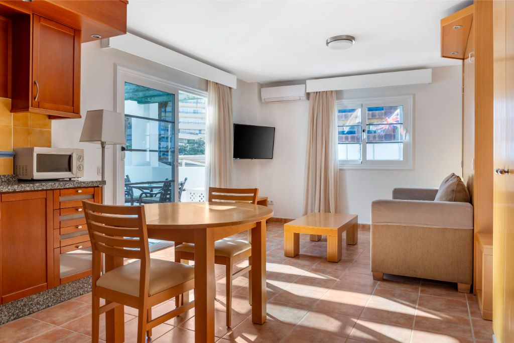 image Dining area adjacent to the living room, suitable for meals and gatherings.