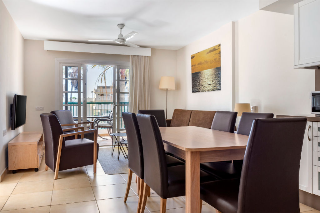 image Open-plan living and dining area with ample natural light, perfect for relaxing and socializing.