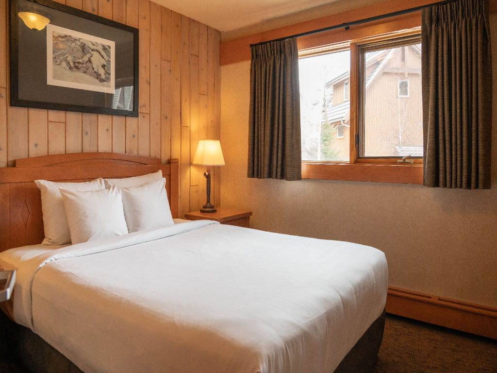 image Sink back into the plush queen-sized bed in the master bedroom.
